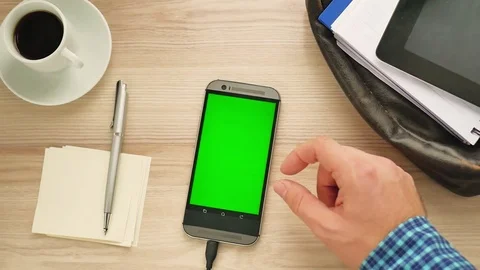 Man using a modern smartphone with green screen at her desk - green screen for p Stock Footage 84046403