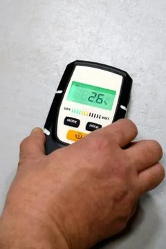 Man using moisture meter for house inspection. Stock Photos