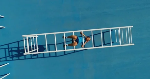 A man using Monkey Bars to do sit ups. 스톡 동영상 86137732