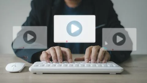 Man using mouse and keyboard for streaming online, watching video on intern.. 스톡 사진