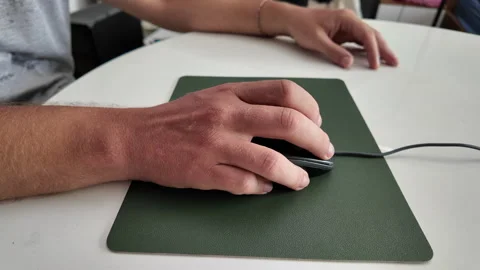 Man using mouse on mouse pad while sitting at desk, close-up, side view Stock Footage 318347194