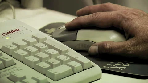 A Man Using the Mouse of an Old Personal Computer in Dark Room. Close Up. Stock Footage 263511362