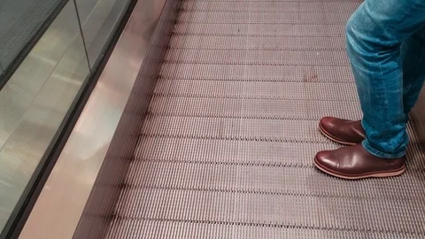 Man using a moving staircase - using a Modern escalator stairs Stock Footage 120136830
