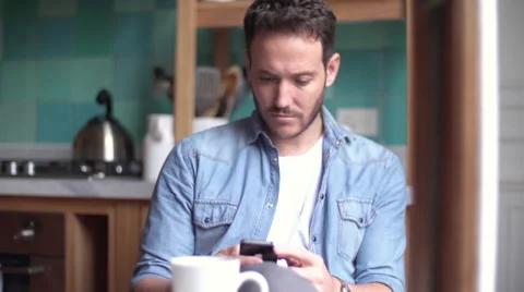 Man using multimedia smartphone at home Stock Footage 63283924