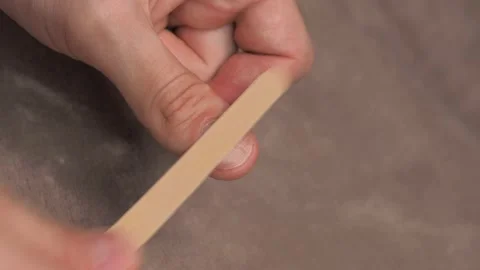 A man using a nail file, cleans off the fungus from the nails Stock Footage 134455246