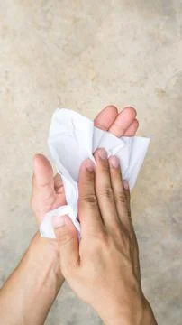 Man using a napkin on gray background. Foto stock
