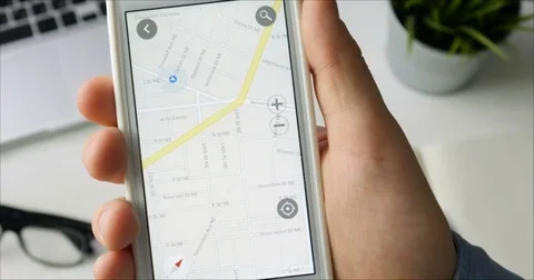 Man using navigation or gps on his smartphone sitting at his desk Stock Footage 78515854