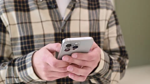 Man using a new mobile iphone 15 close-up, texting message, scrolling Stock Footage 273741237