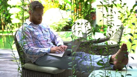 Man using notebook and showing thumbs up to the camera in the garden Stock-Footage 79389904