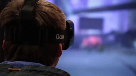 Man using Oculus virtual reality glasses in video game in game center Stock Footage 80897873