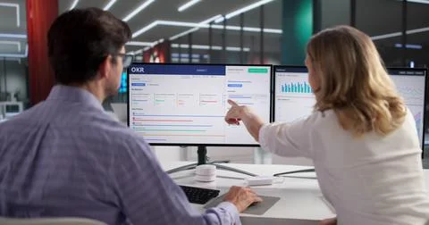 Man Using OKR Dashboard For Financial Market Analysis And Strategy Planning. Stock Photos