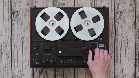Man using Old portable reel to reel tape recorder Stock Footage 99507800
