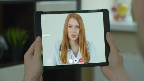 Man using online chat to talk with professional therapist and checks possible Stock Photos
