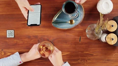 Man using online menu in cafe top view, scanning qr code with smartphone in Stock Footage 168691063