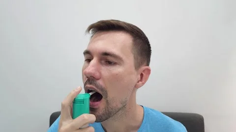 Man using oral spray in his mouth. Healthcare and medication concept. Video stock 284043099