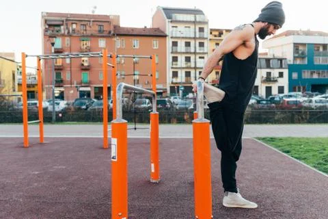 Man using parallel bars in outdoor gym Stock Photos