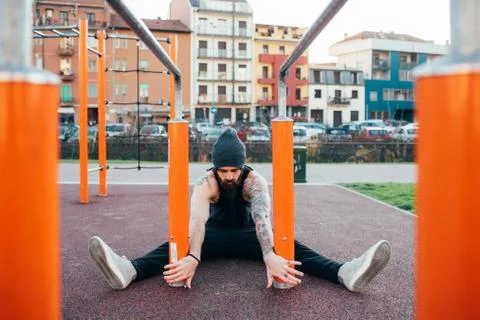 Man using parallel bars in outdoor gym Stock Photos