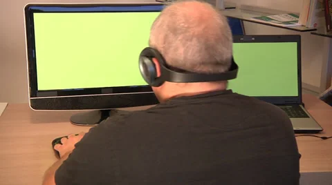 Man using PC and laptop, headphones with key green screen. Video stock 32168168