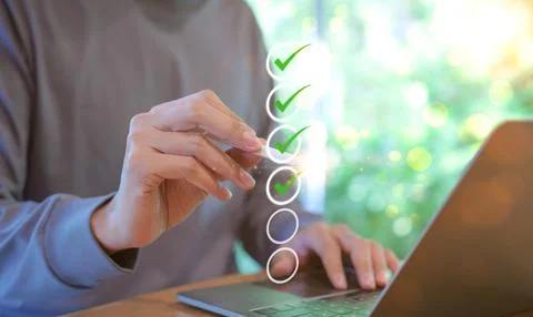 Man using pen to tick correct sign mark in checkbox for quality document Stock Photos