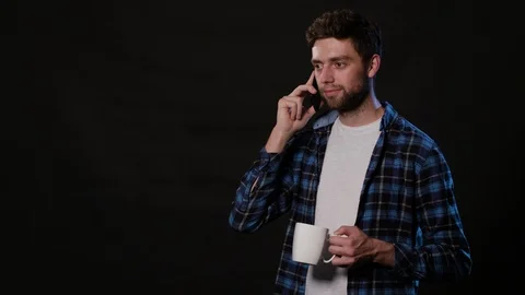 A Man Using a Phone Against a Black Background Stock Footage 88412679