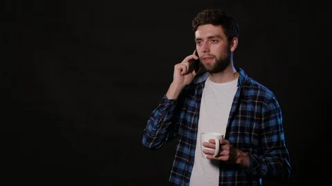 A Man Using a Phone Against a Black Background Stock Footage 88412870