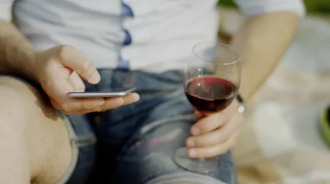 Man using phone and drinking wine Stock Footage 68265944