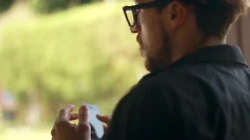 Man is using phone and touching his hair. Video stock 85524276