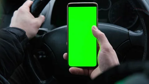 Man using phone with blank green background while driving. Stock Footage 301074395