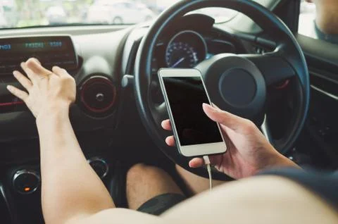 Man using phone in the car Stock Photos
