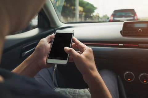 Man using phone in the car Stock Photos