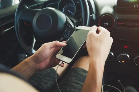 Man using phone in the car Stock Photos