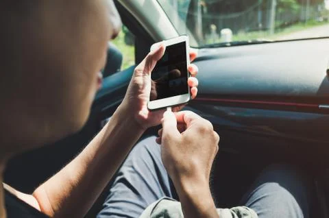 Man using phone in the car Stock Photos