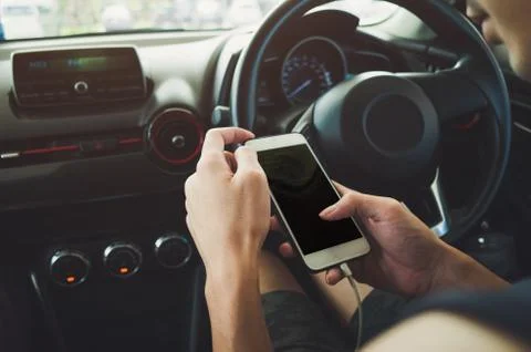 Man using phone in the car Stock Photos