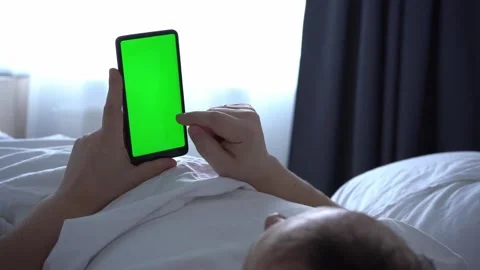 Man using phone chroma key green screen typing text reading social media closeup Stock Footage 170128831