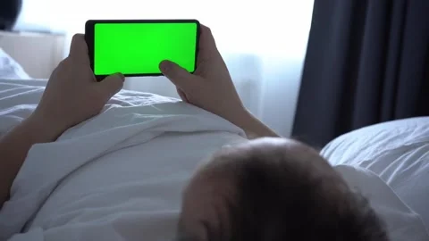 Man using phone chroma key green screen typing text reading social media closeup Stock Footage 170128863