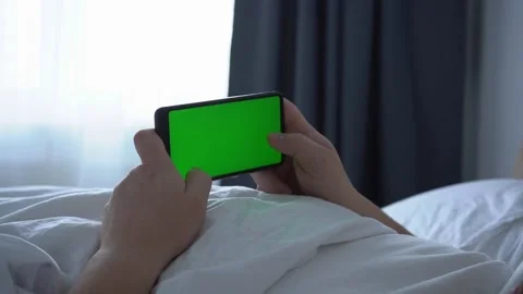 Man using phone chroma key green screen typing text reading social media closeup Stock Footage 170128926