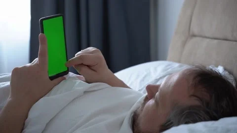 Man using phone chroma key green screen typing text reading social media closeup Stock Footage 170128982