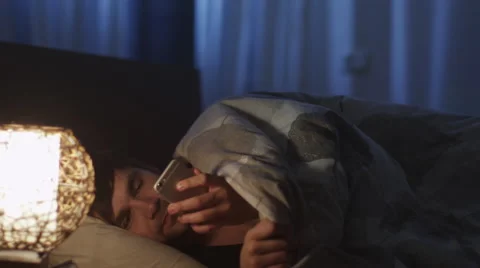 Man Using Phone Before go to Sleep and Switching Off Night Light Stock Footage 49741859