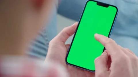 Man Using Phone with Green Mock-up Screen, Social Networks, Browsing News Stock Footage 220794202