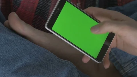 Man using phone with green screen. Shot on a digital camera in 4K, so you can Stock Footage 73976812