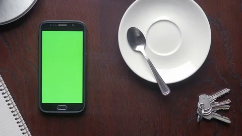 Man using a phone with green screen for replacement and drinking coffee Stock Footage 74482345