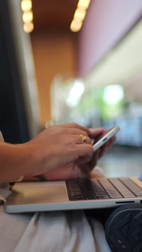 Man Using Phone With Laptop In Library, Representing... Stock Footage 344455149