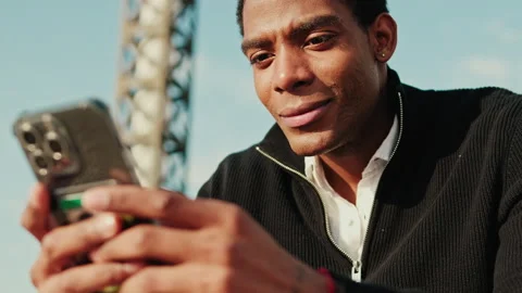 Man Using Phone Outdoors on Sunny Day Stock Footage 303289624