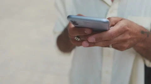 Man Using Phone in White Shirt. Close up, focus on the phone Stock Footage 314268235