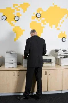 A man using a photocopier at work Stock Photos