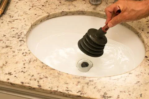Man Using Plunger Stock Photos