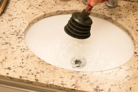 Man Using Plunger Stock Photos