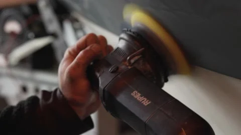 Man using a polishing machine to polish a boat Stock Footage 202246177