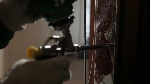 Man using polyurethane foam for installing new door Stock Footage 70913523