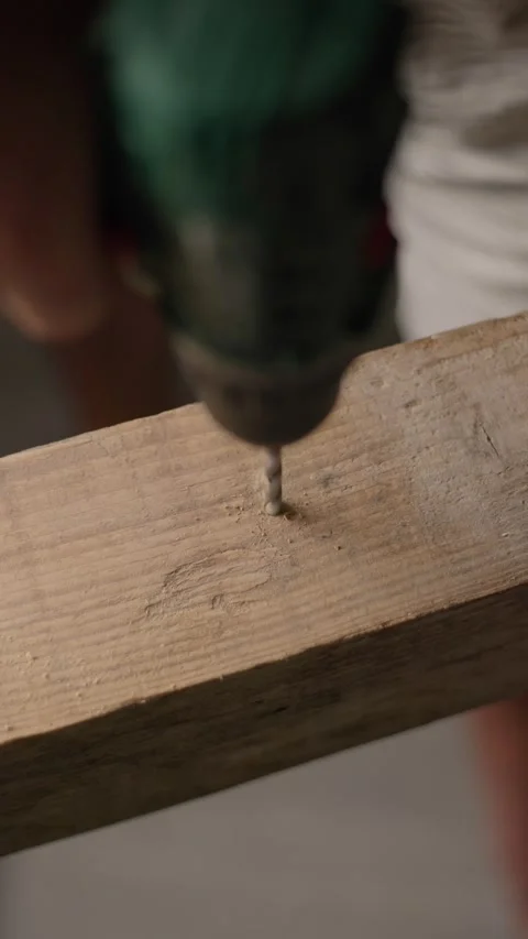Man using a power drill to bore a hole into a wooden plank 스톡 동영상 344601383